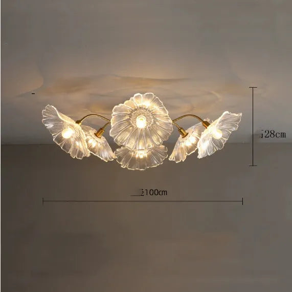 Modern ceiling lamp with cluster of artificial white flowers and warm glowing light.