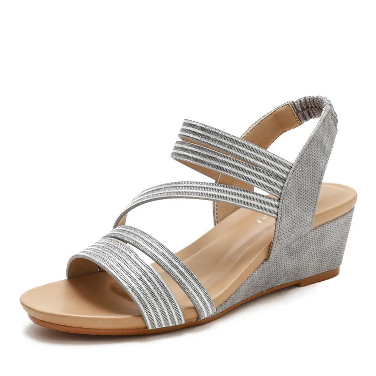 Women's gold platform sandals with a mid-heel on a white background
