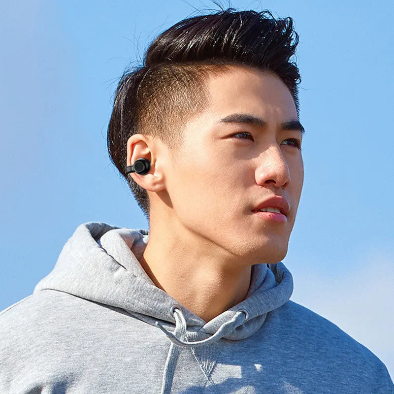 Black wireless Bluetooth bone conduction headset with clip-on design for exercise