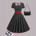 Multicolour polka dot pleated midi dress with a square collar and short sleeves on a hanger.