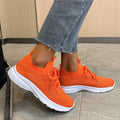 Women's low-top mesh running shoes in creamy white with a flat rubber sole and distinctive English muffin heel detail.