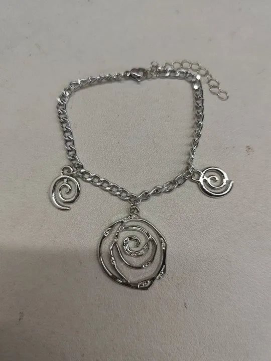 Spiral donut design jewellery set showing necklace, bracelet and ear hooks in gold finish