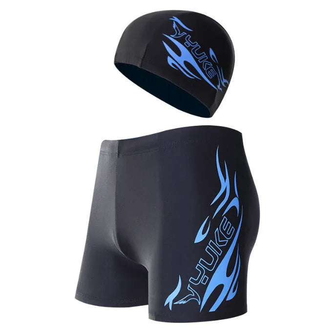Men's plus-size blue fire pattern boxer swim trunks laid flat, with matching swimming cap.