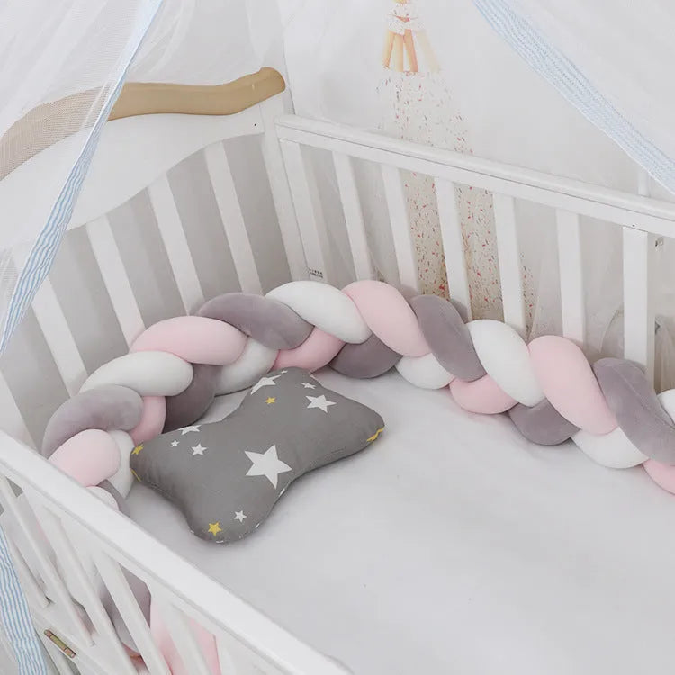 Long, flexible baby crib bumper pillow in spandex velvet, shown fitted around a white cot for safety protection.