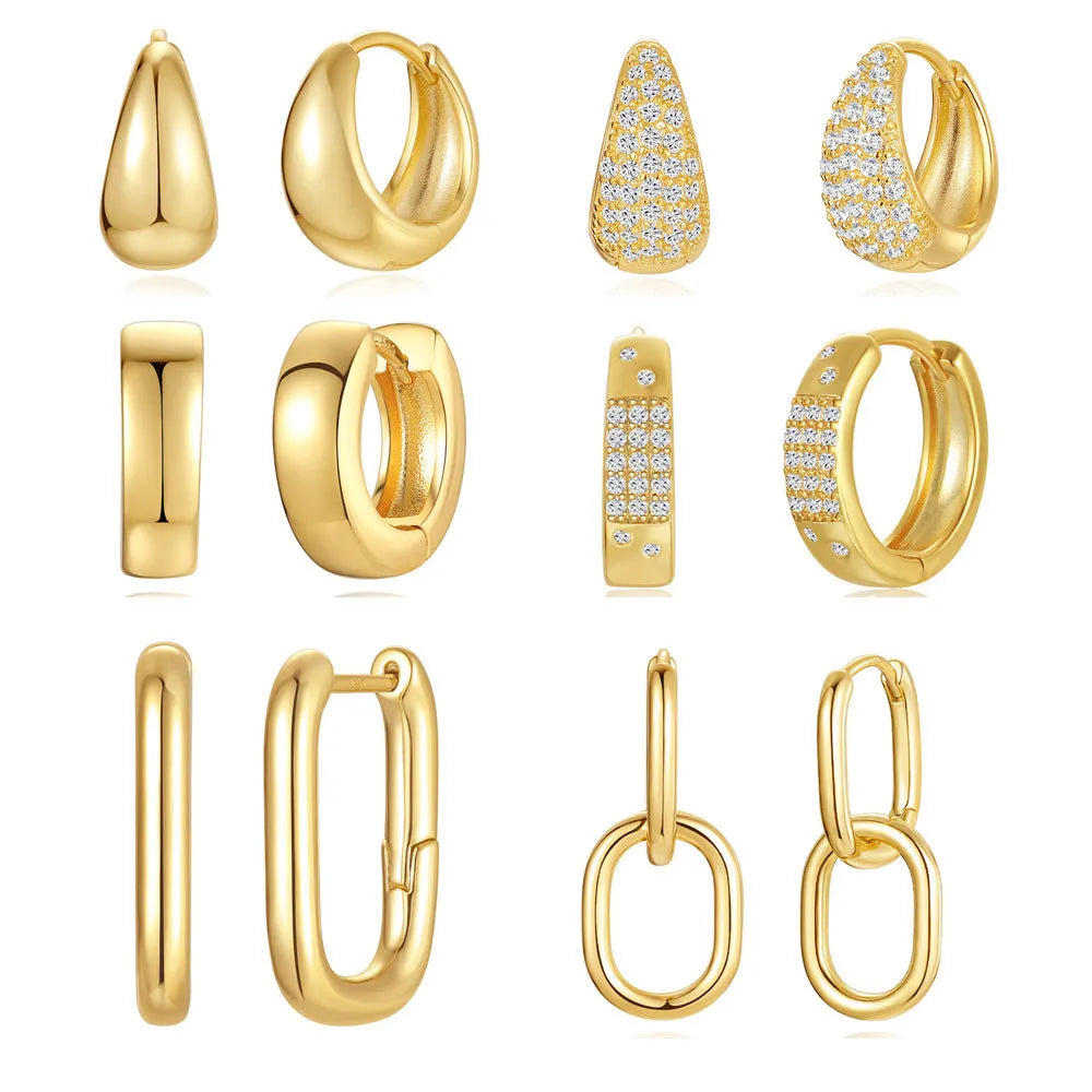 A pair of geometric brass earclip earrings with round diamond details on a gold electroplated copper base.