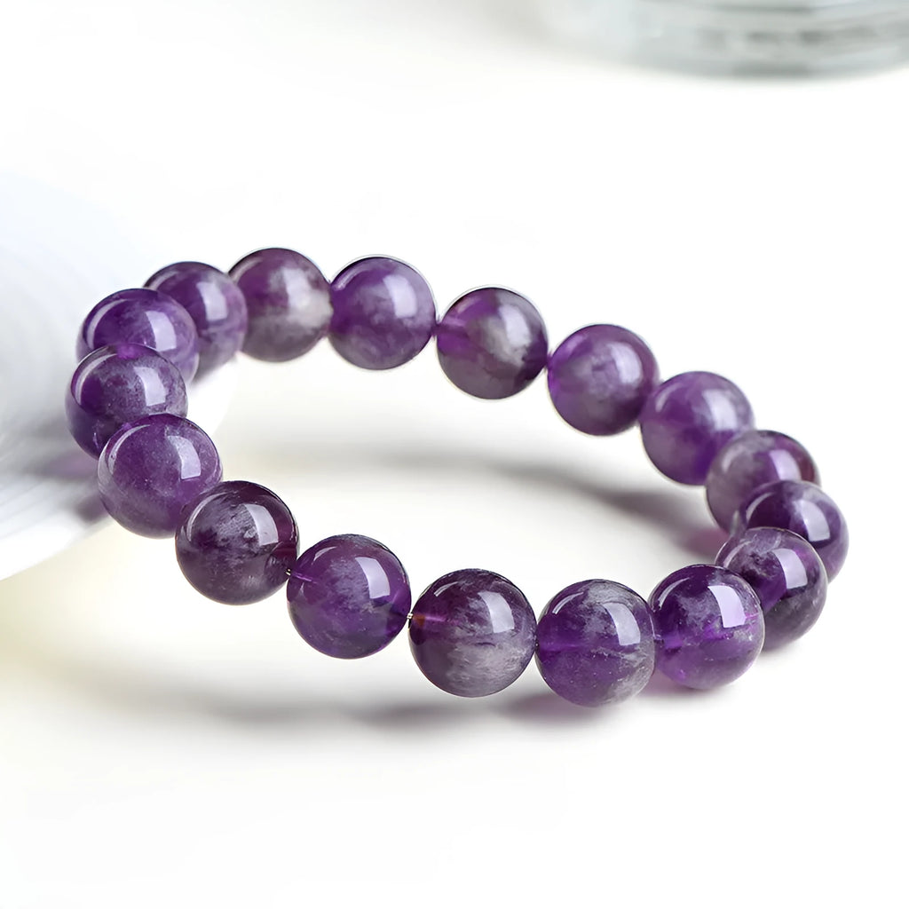 Natural feather amethyst crystal bracelet with geometric beads and Ruyi symbol in Snow Mountain purple.