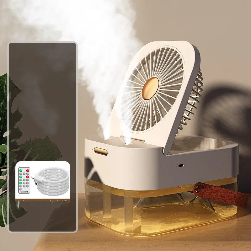 Pearl white desktop humidifier cooling fan with water tank, remote control, and night light on a wooden desk.