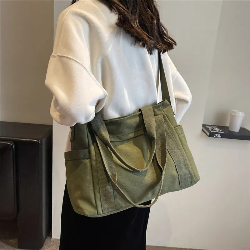Large solid colour polyester shoulder tote bag with external pocket and internal phone compartment