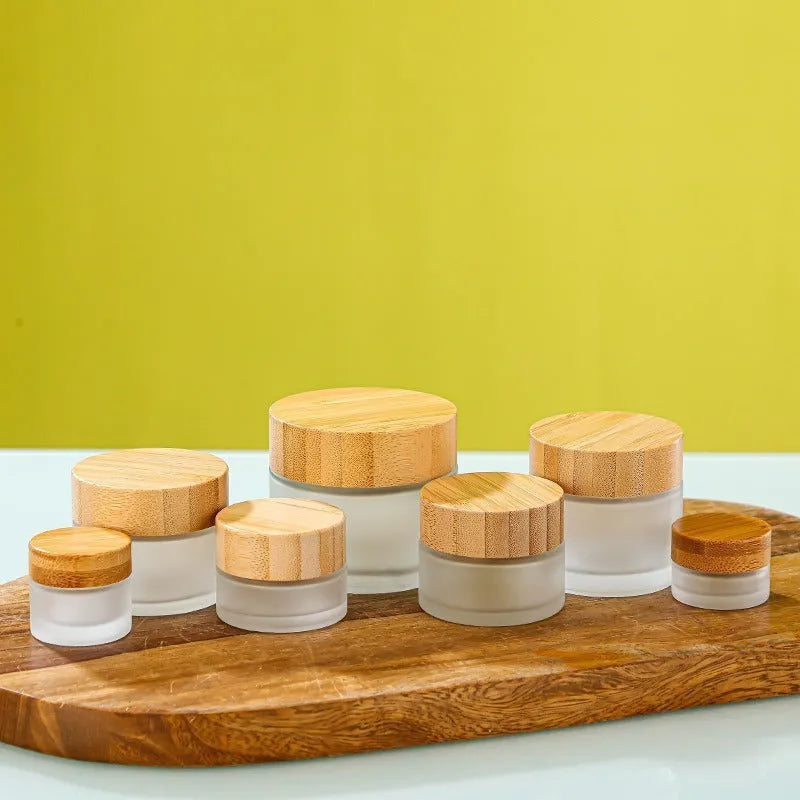 Refillable glass cream jar with bamboo wood lid, transparent finish, 100g capacity