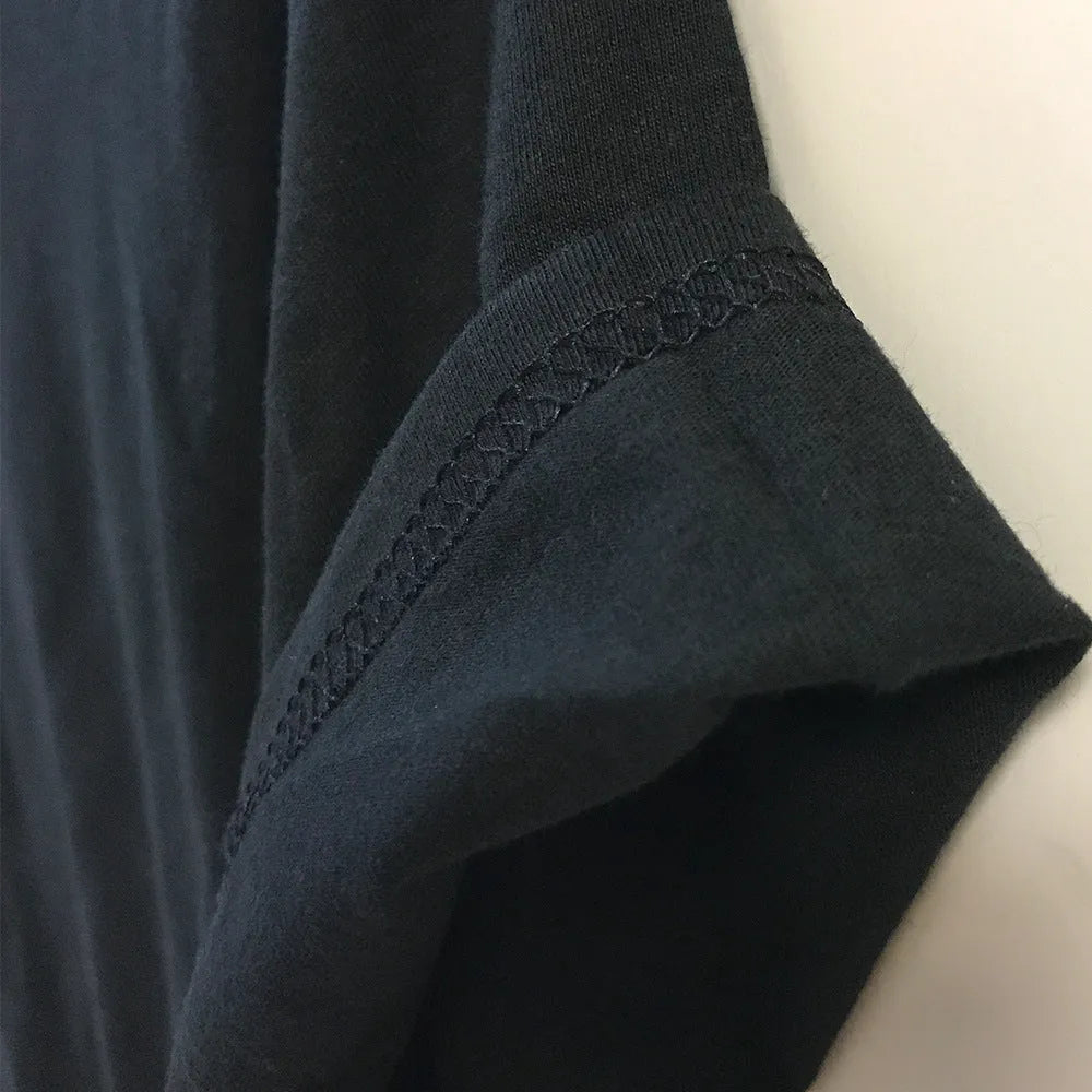 Funny Obedient And Reproducible text printed on a loose fit black cotton t-shirt.