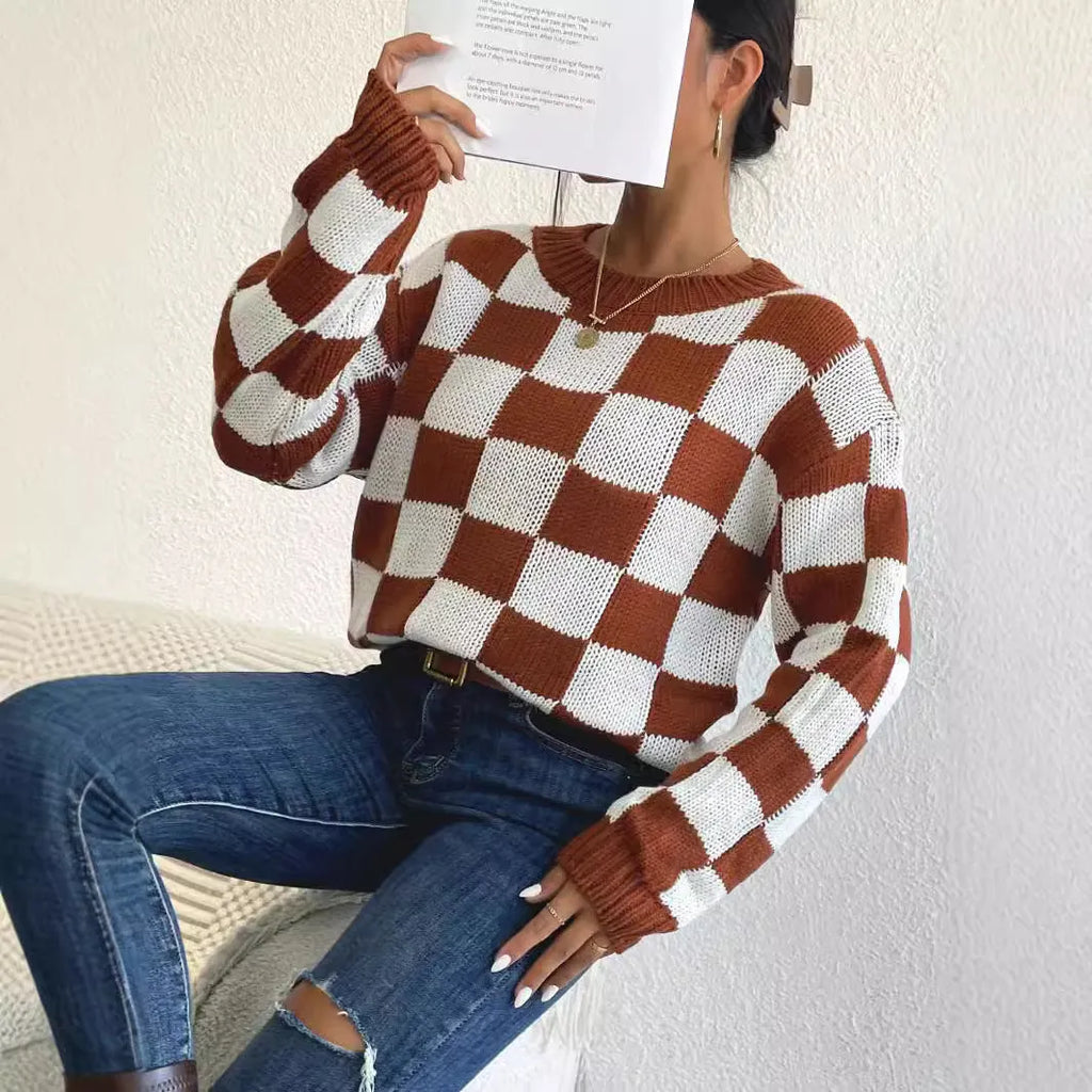 Dark brown plaid loose fit acrylic pullover sweater with long sleeves on a hanger.