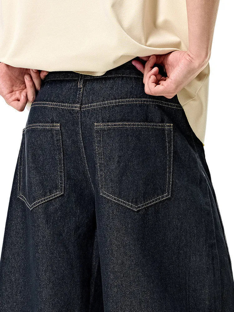 Men's wide leg denim trousers in original cow colour showing relaxed fit and mid waist design.
