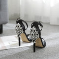 Black women's high heel shoes with rhinestone details on the suede upper and a fish mouth toe.