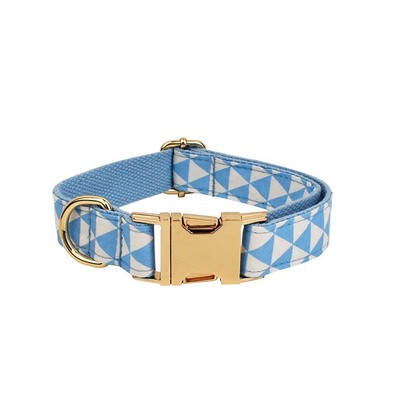Blue cloth dog vest set with matching collar, leash, and bow tie on a white background