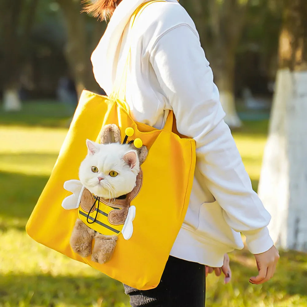 Soft canvas pet carrier shoulder bag for small cats and dogs in a cartoon pattern design.