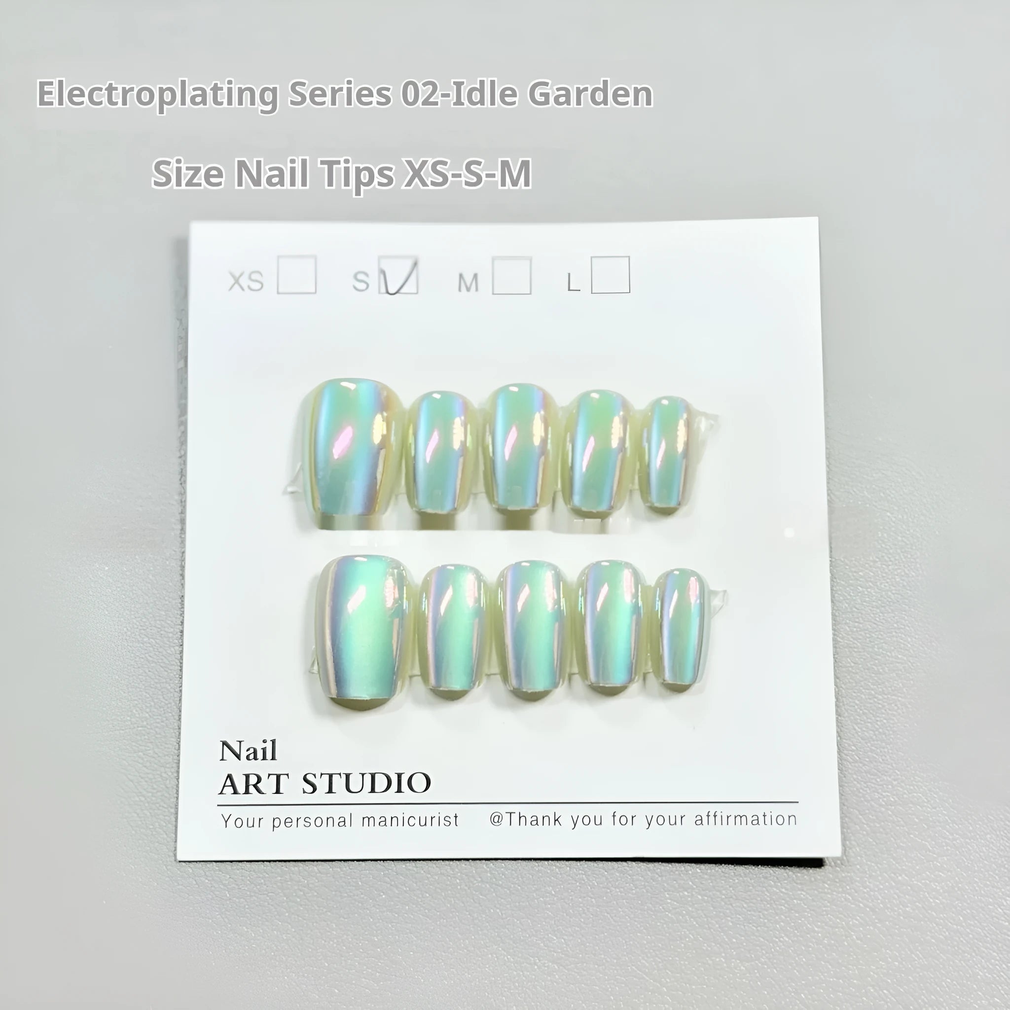 Set of false nails with electroplated cat's eye and aurora design on short ladder shaped tips.