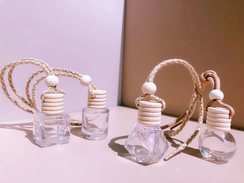 Glass car perfume pendant fragrance diffuser in cylinder, diamond, flat drum, and square styles.