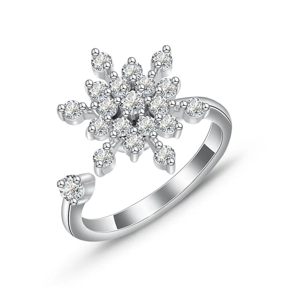 Gold tone adjustable spinner ring with rotating band and bee daisy design with blue zircon stones