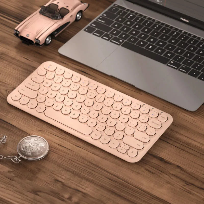 Mute brand ultra-thin wireless keyboard and mouse set with USB receiver on a wooden desk.
