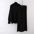 Women's beige acrylic knit long-sleeve sweater and matching wide-leg trousers set on a hanger.