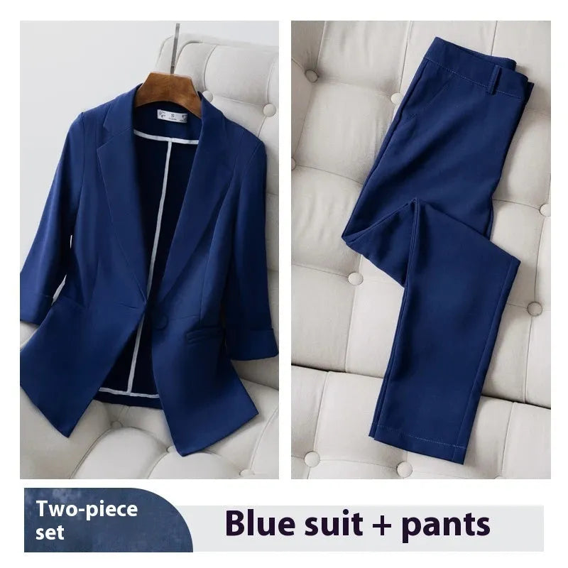 Blue polyester formal suit set with long sleeve jacket and cropped pants on a model