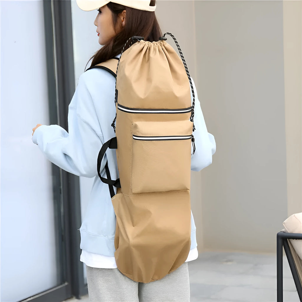 Roll-up skateboard bag in black nylon with an adjustable shoulder strap, shown carrying a skateboard.