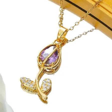Gold tulip pendant necklace on an adjustable O-ring chain, showing non-fading electroplated finish.