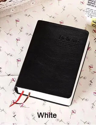 Large thick leather Phnom Penh notebook in gold, A6 size, 480 pages, open on a desk