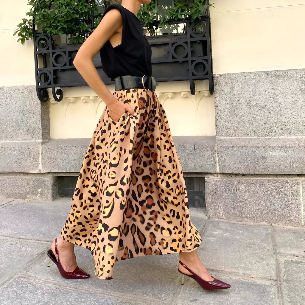 Brown leopard print women's long A-line skirt with a full hem on a hanger