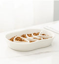 Ceramic shallow cat bowl in black on a light background, showing wide lip and low profile for whisker comfort