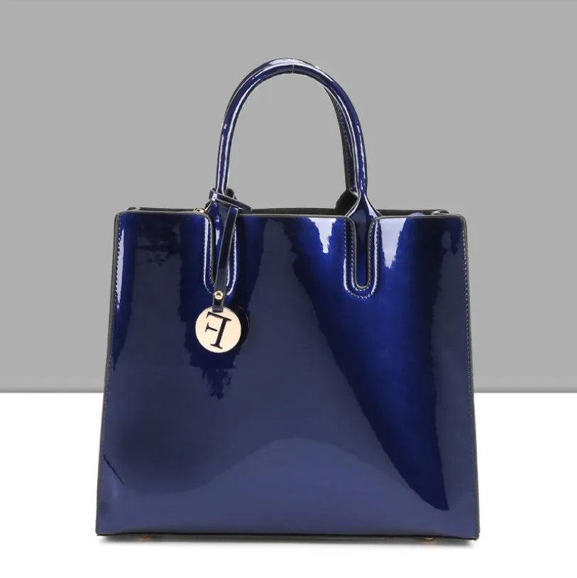 Three soft patent leather handbags in solid colours for women, shoulder and crossbody style with zipper closure