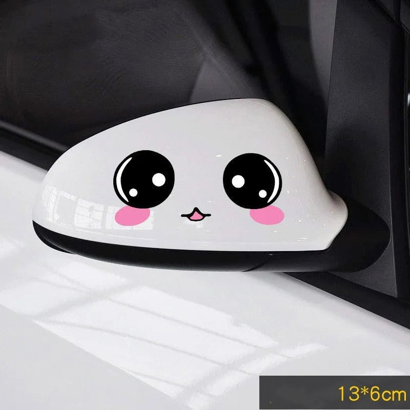 Pair of reflective cartoon eye car stickers on a vehicle rearview mirror and door panel.