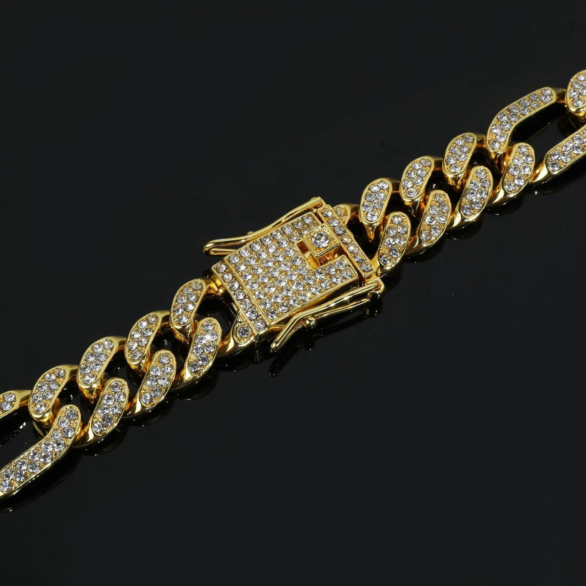 Rap style figaro chain necklace with geometric rhinestone pendant in silver colour on a plain background