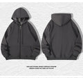 A beige men's heavyweight hooded zip-up sweater showing kangaroo pockets and a loose fit on a man.