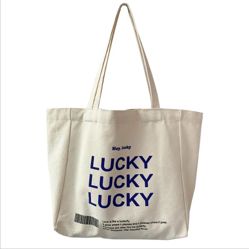 Natural canvas tote bag 32x31.5x10cm with bottom and side panels, small pocket, and metal magnet buckle