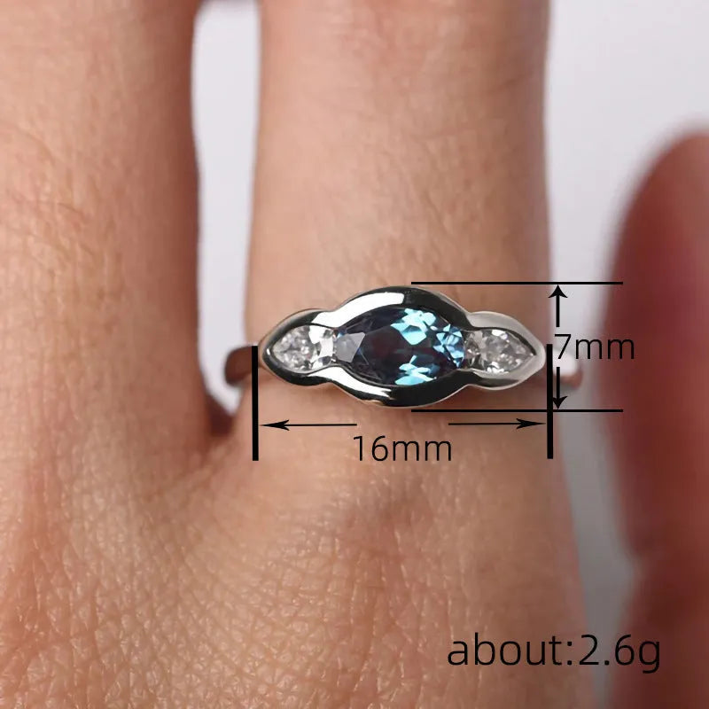 Geometric ellipse ring with zircon inlay in white gold colour, showing contemporary jewellery design