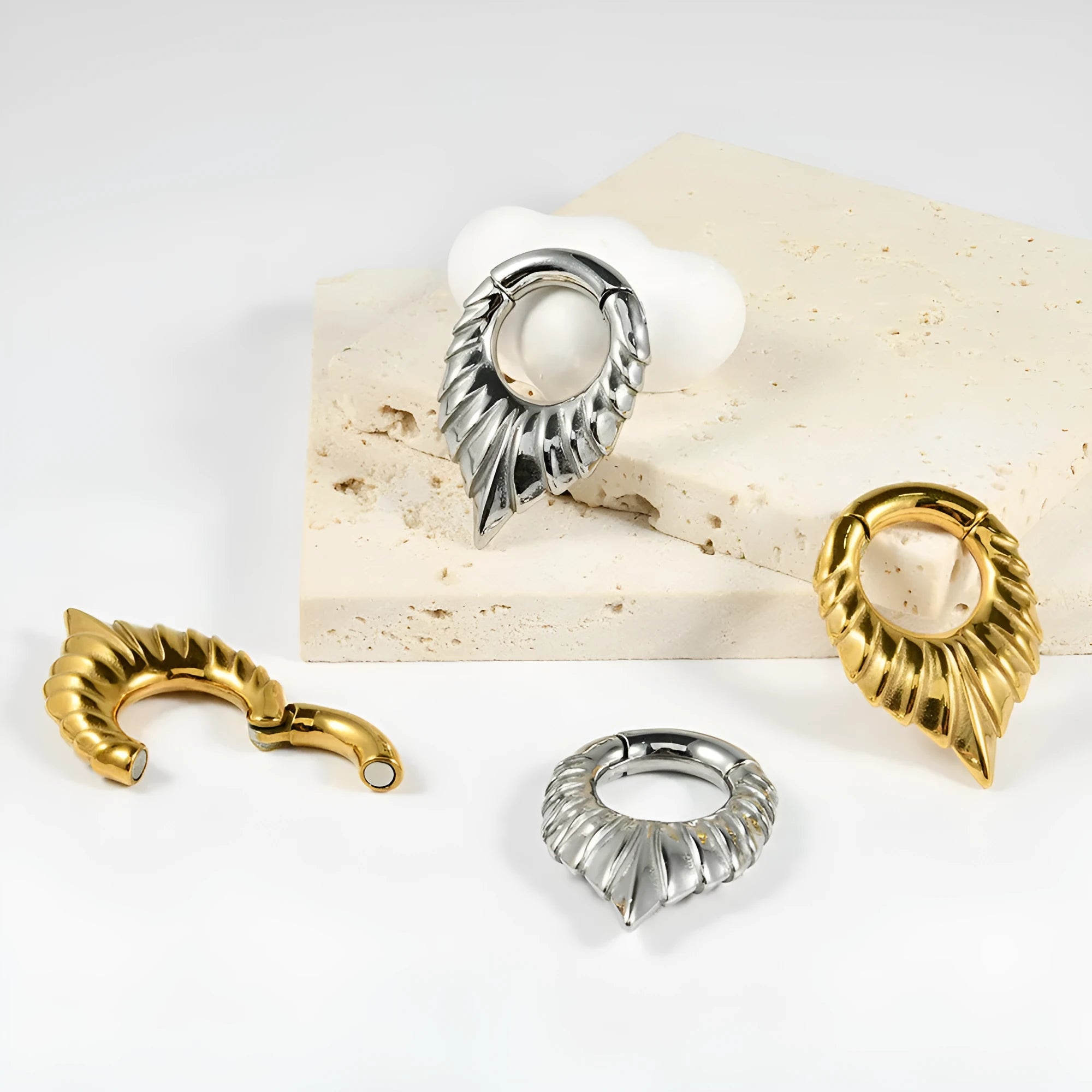 Drop-shaped teardrop earlobe stretcher in stainless steel with a coloured finish and totem detailing.
