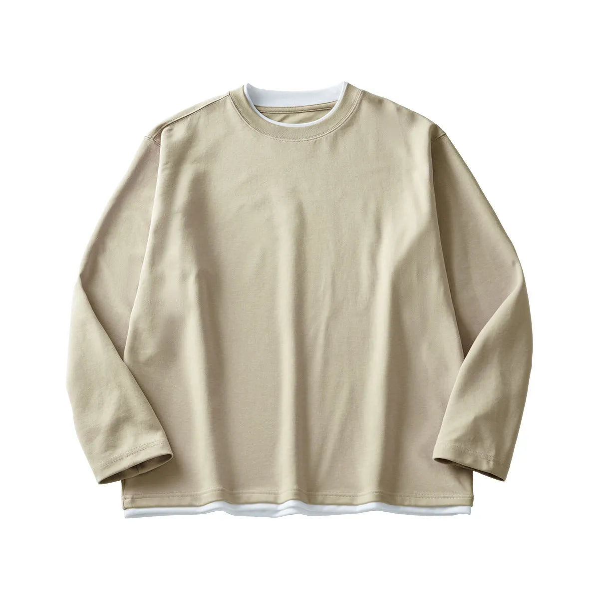 Man wearing a loose fit long-sleeved round neck t-shirt in a solid colour