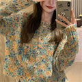 Pink and green rainbow pattern knitted cardigan on a hanger, showing slim fit and regular sleeves.