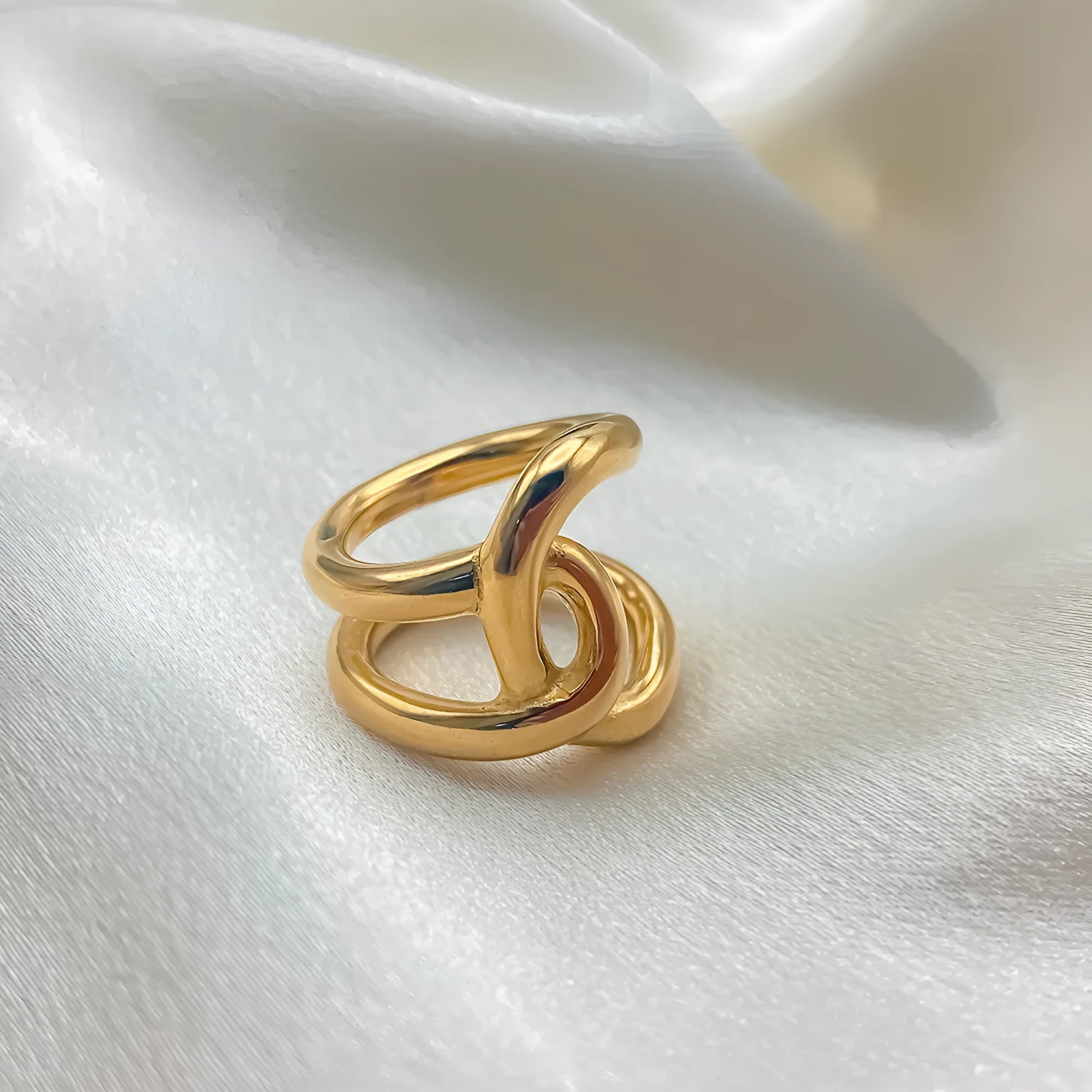 Adjustable knotted stainless steel ring for women in 18K gold or steel colour, showing U-shaped geometric design.