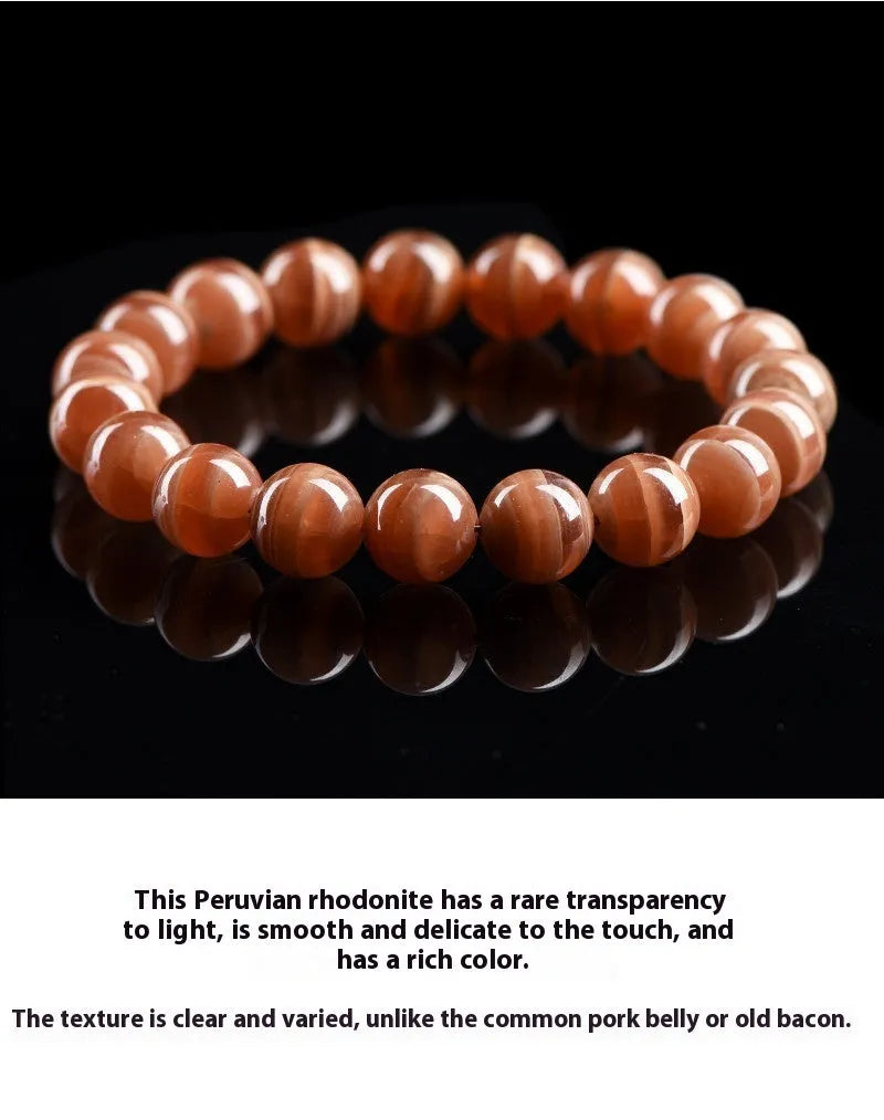 Natural Old Mine Rhodochrosite round bead bracelet on wrist, showing manganese spar colour.