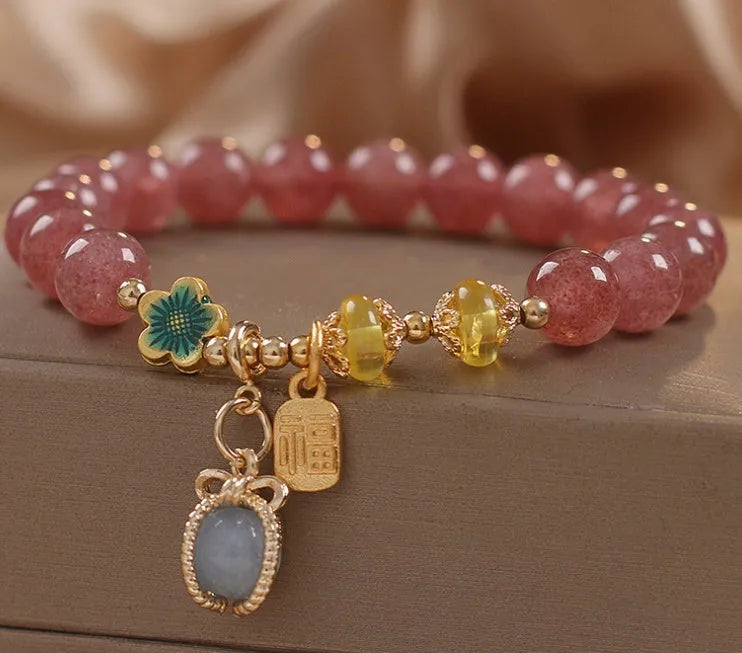 Red women's beaded bracelet with a strawberry quartz centre stone and sparkling rhinestones on an alloy chain.