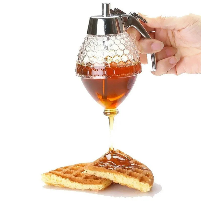 Transparent squeezable honey jar dispenser with 200ml capacity and bee design, sitting on a kitchen counter