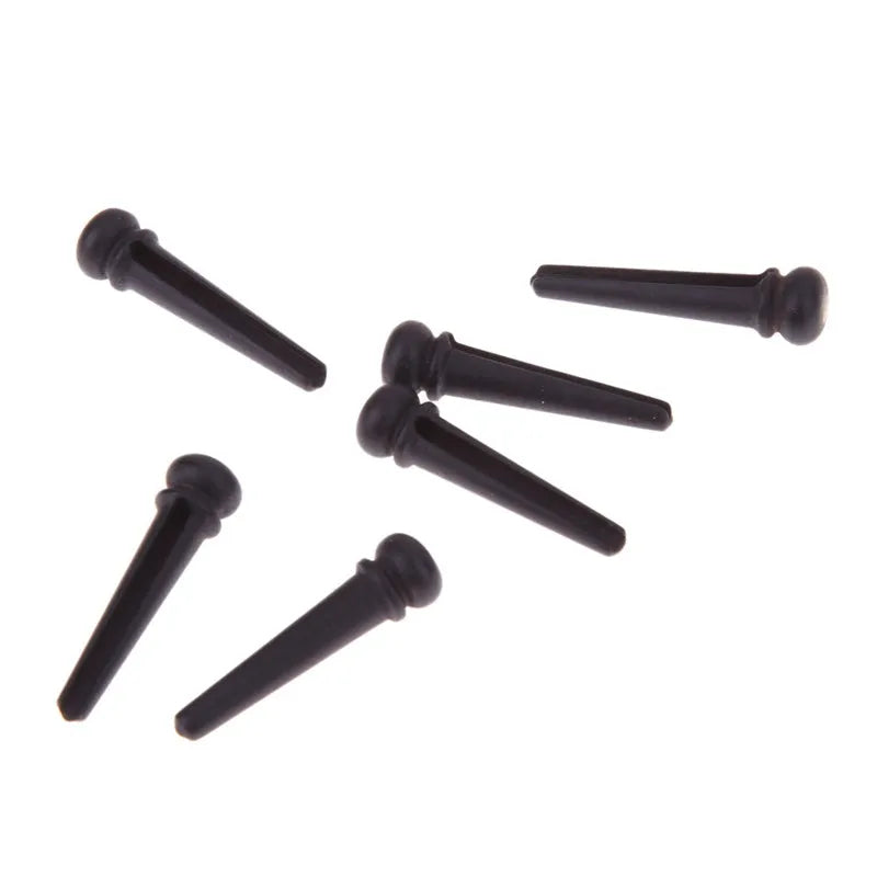 Six ebony guitar bridge pins with matt black finish and 5.3mm bayonet diameter