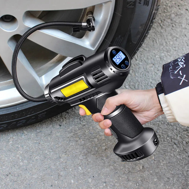 A black wireless electric tyre pump with digital display, charging cable, and air nozzles on a grey background.