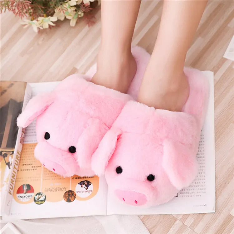 Pink pig-shaped plush floor slippers with PP cotton filling on a plain background