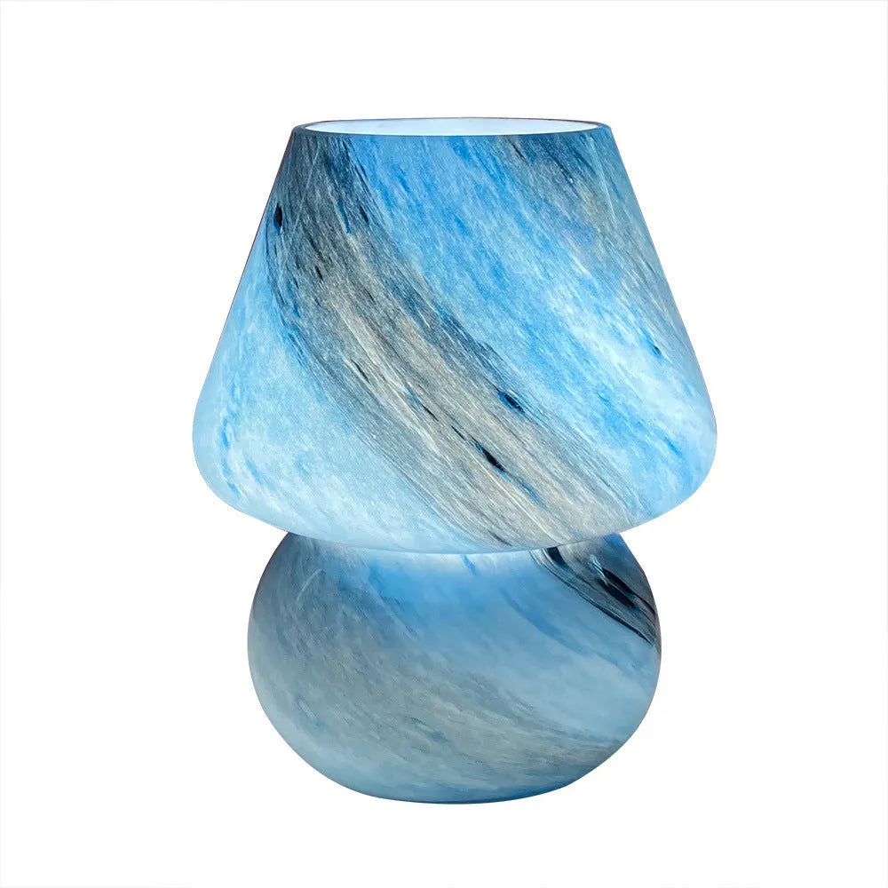 Handmade glass mushroom table lamp in Earth colour finish on a bedside table, showing its compact 15x19cm size