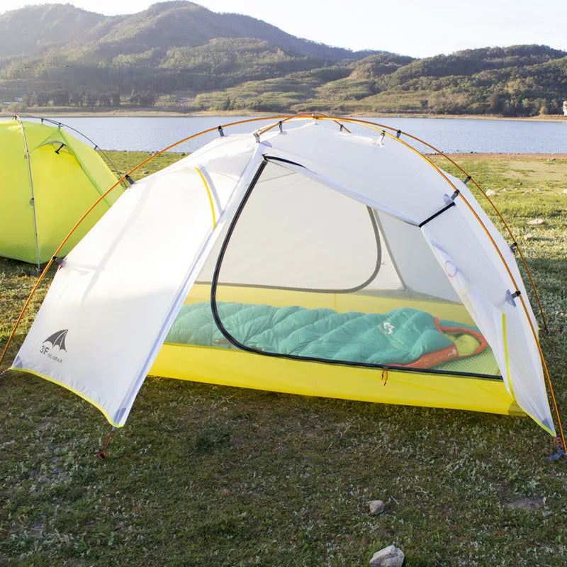 Green camouflage double layer camping tent with two room one hall layout set up outdoors