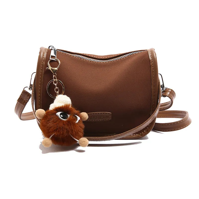 High-textured PU messenger bag with leopard print, horizontal square shape, and decorative pendant