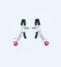 Red single bell nipple clamp pair with reel chain and two gold bells on white background